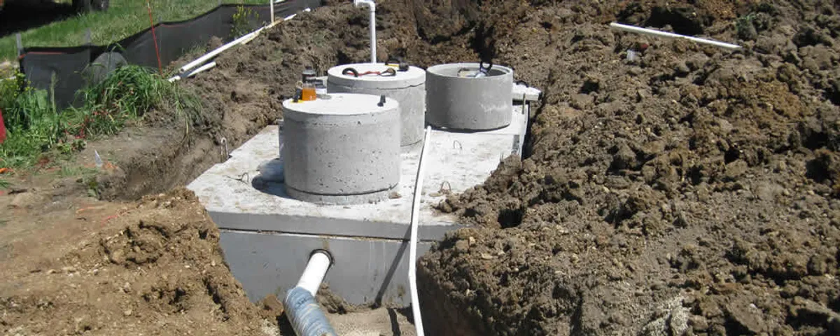 Septic system repair and installation site with tank access ports in Troy, MI